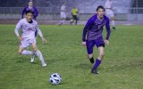 Lemoore's Blake Nunes charges the ball during Friday's wet Division 3 playoff game against McLane which the Tigers won 3-1 to advance to the semi-finals.